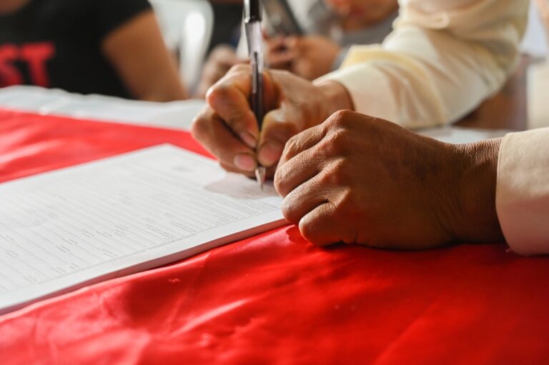 Person signing a contract representing mid-contract price increase disputes