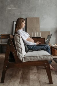 Pregnant employee working at a desk in an office setting