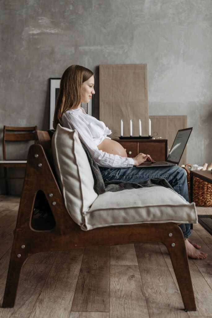 Pregnant employee working at a desk in an office setting