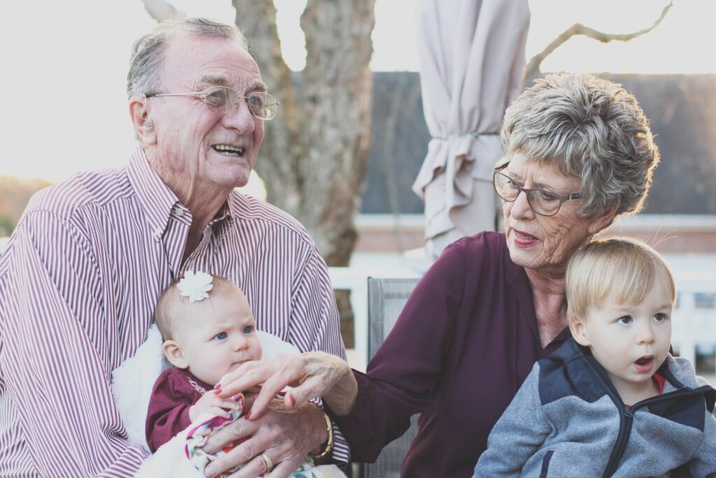 Grandparents spending time with young grandchildren outdoors