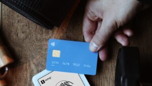 A person pays for a gym membership with a card at a reception desk