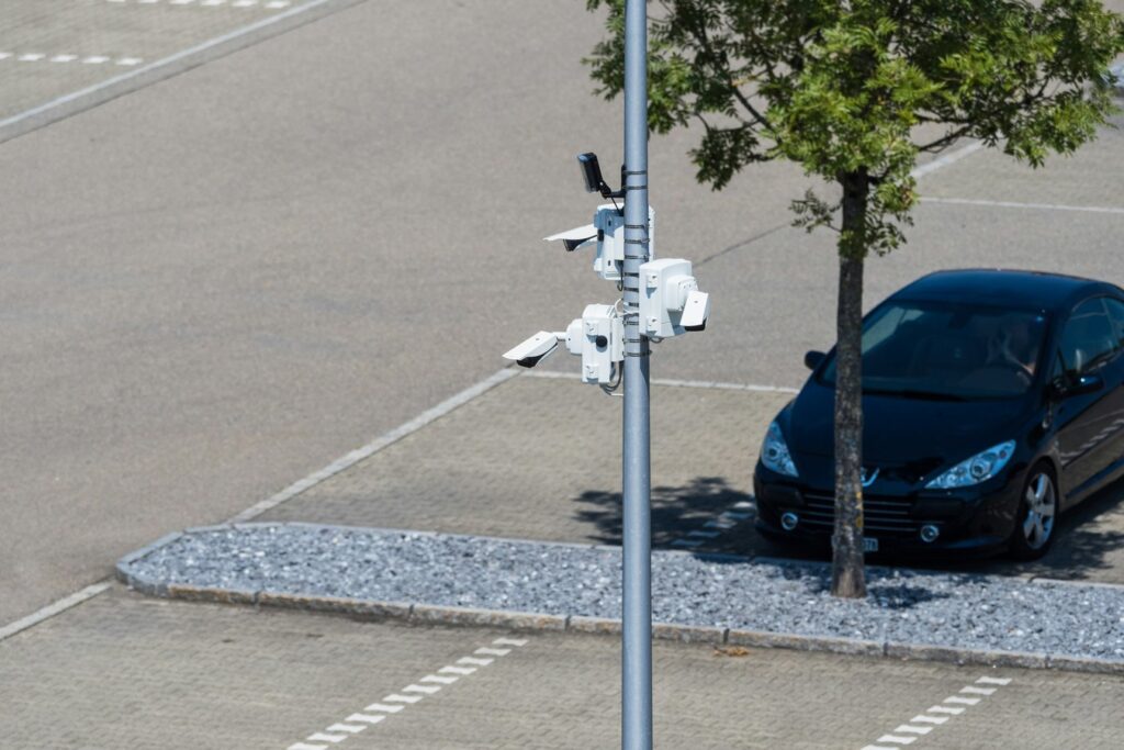 Security cameras monitoring a parking lot, illustrating negligent security and premises liability concerns.