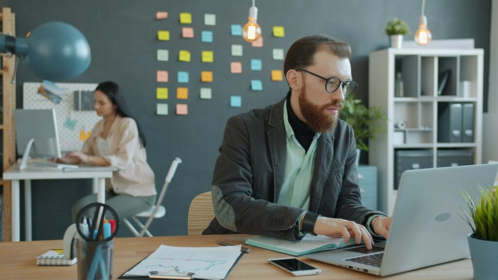 Two colleagues collaborating at a modern office desk