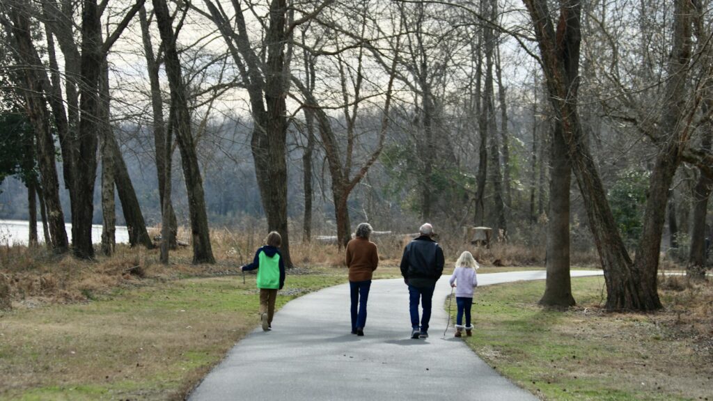 Family walking along a park path