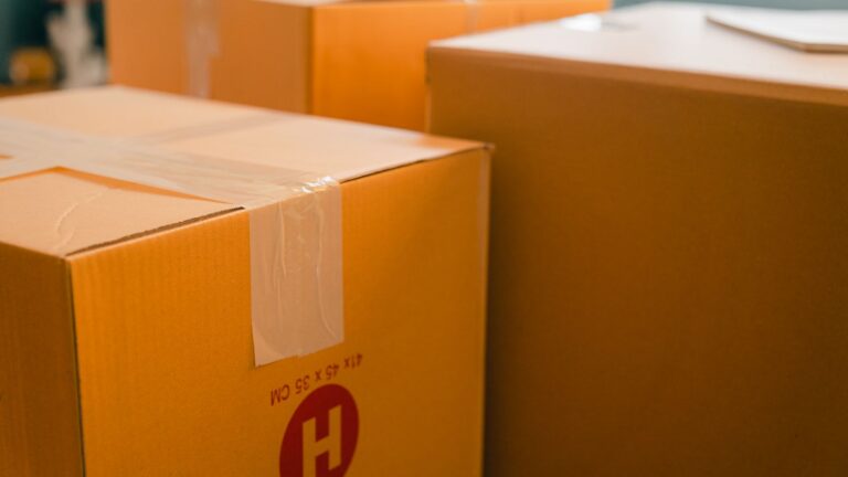 Packed cardboard boxes beside a window